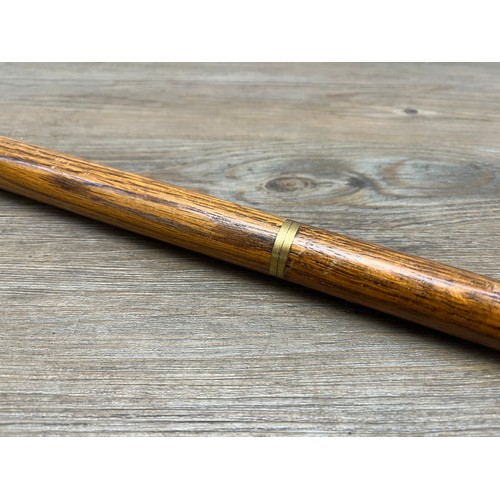 433B - A mid 20th century oak and brass novelty duck walking stick