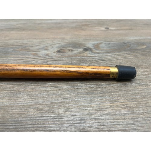 433B - A mid 20th century oak and brass novelty duck walking stick