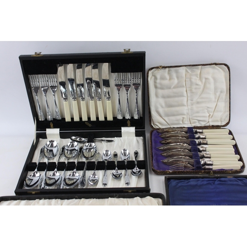 390A - Four boxed silver plated and ivorine cutlery sets