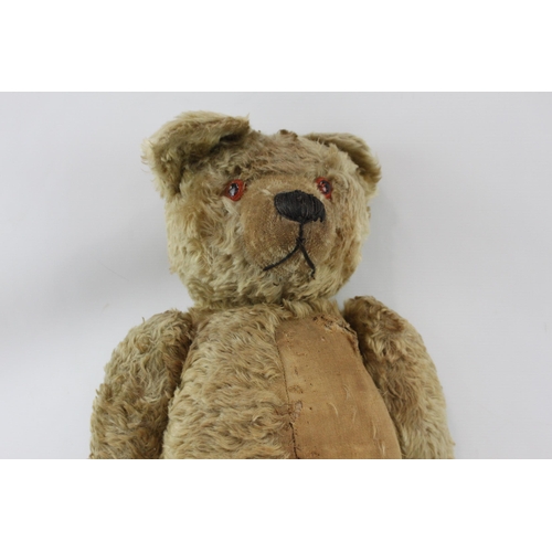 411 - A vintage golden mohair jointed teddy bear with leather paws and growler