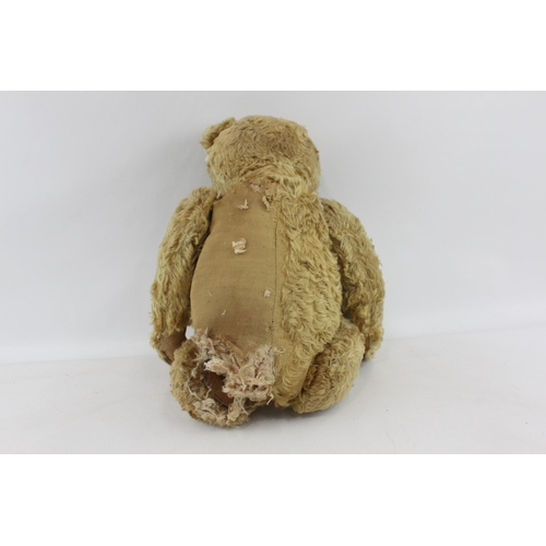 411 - A vintage golden mohair jointed teddy bear with leather paws and growler