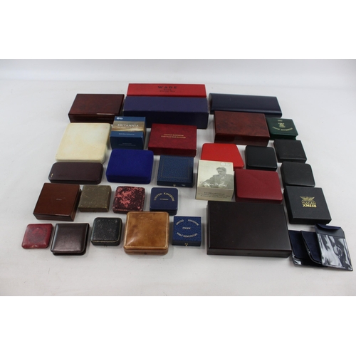 523 - A large collection of coin/medal boxes to include Britannia, Royal Mint etc.