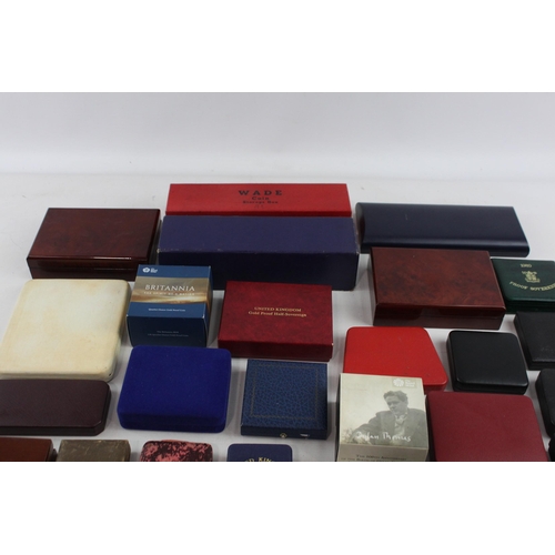 523 - A large collection of coin/medal boxes to include Britannia, Royal Mint etc.