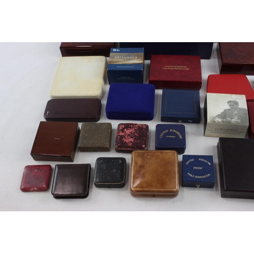 523 - A large collection of coin/medal boxes to include Britannia, Royal Mint etc.