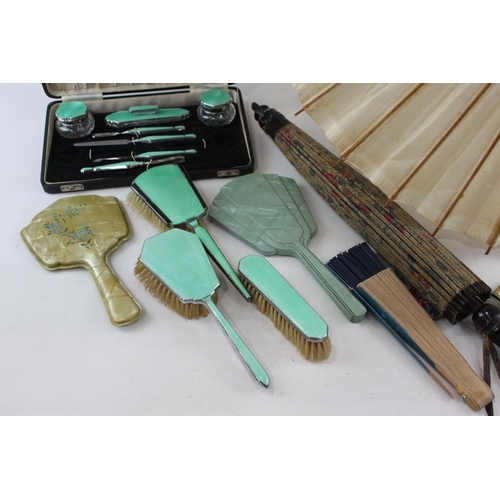 526 - A collection of vanity items to include parasol, guilloche enamel brushes etc.