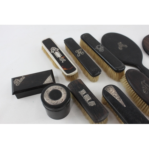 537 - A collection of antique ebony vanity items with hallmarked sterling silver detailing