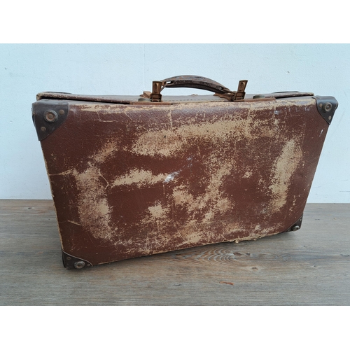 581 - A vintage suitcase containing a collection of reel-to-reel tapes to include examples marked 'First M... 