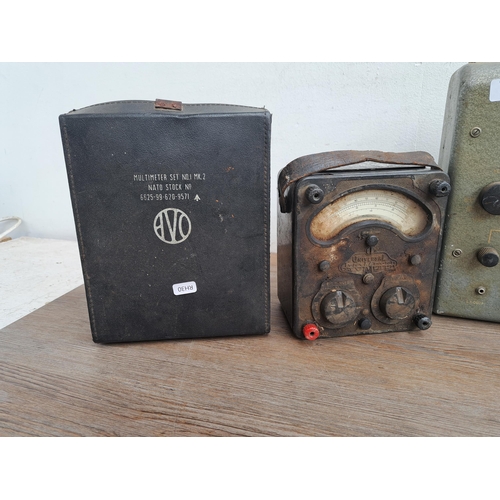 682 - Three AVO meters together with two  military issue cases, one Mk II and one other