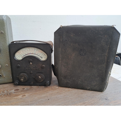 682 - Three AVO meters together with two  military issue cases, one Mk II and one other