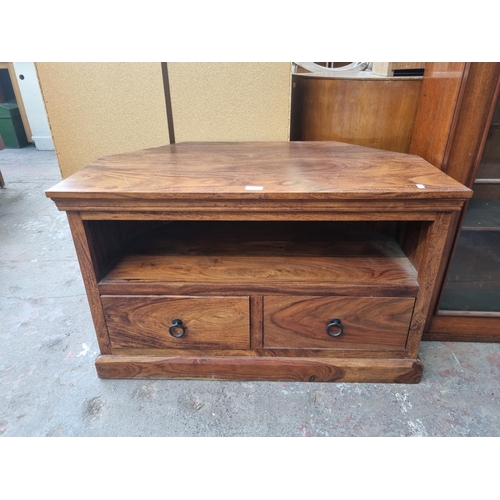 102 - An Indian sheesham wood two drawer TV stand