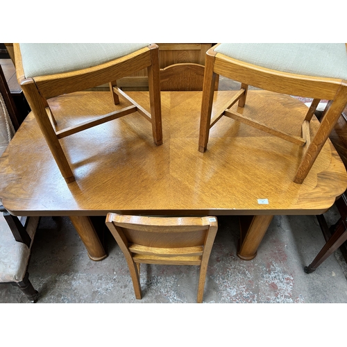 136 - An Art Deco oak and walnut dining table and four matching chairs