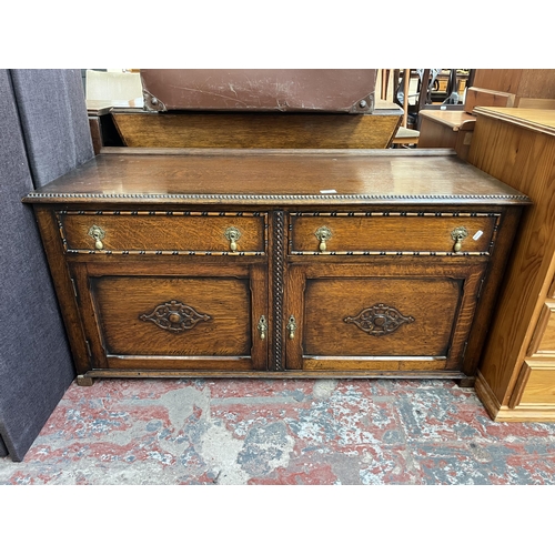 149 - An early 20th century carved oak sideboard