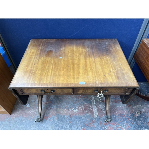 194 - An early 20th century Regency style walnut and mahogany crossbanded two drawer sofa table with brass... 