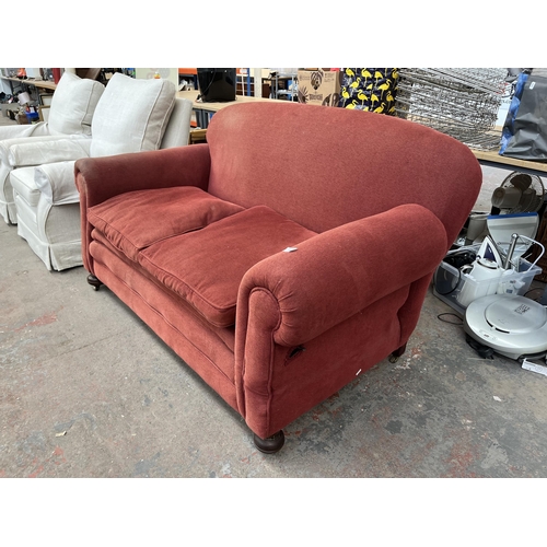 239 - A Victorian red fabric upholstered drop arm sofa