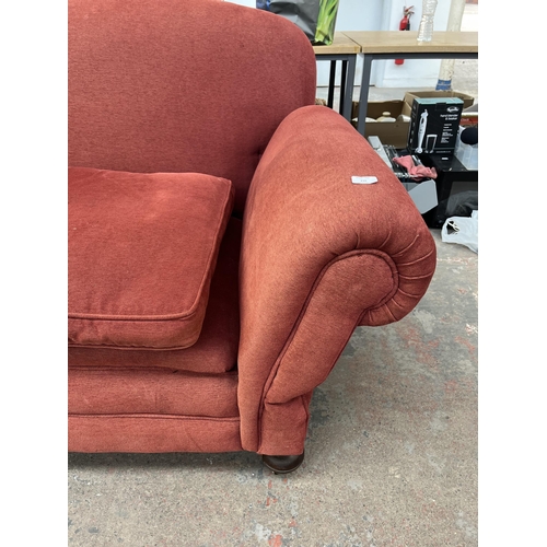 239 - A Victorian red fabric upholstered drop arm sofa