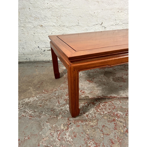 105 - A Chinese hardwood rectangular coffee table - approx. 40cm high x 56cm wide x 122cm long