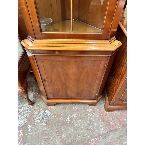 107 - A Bradley yew wood free standing corner cabinet