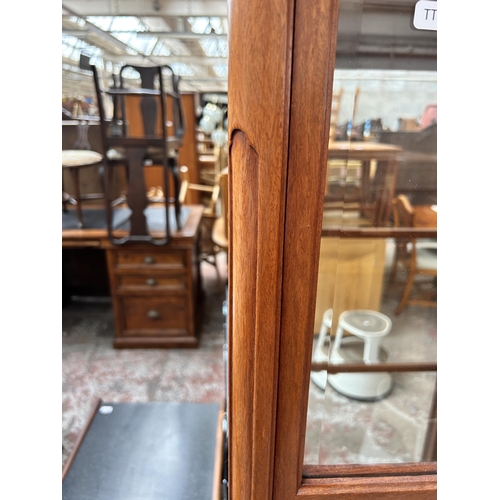 108 - A Chinese hardwood and bevelled glass display cabinet with two glass shelves and cabriole supports -... 