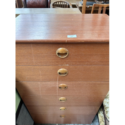 112 - A teak chest of drawers - approx. 107cm high x 61cm wide x 40cm deep