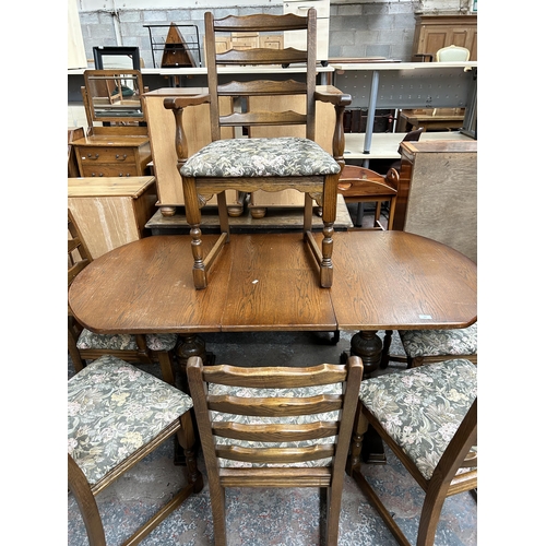 123 - An oak twin pedestal extending dining table and six chairs