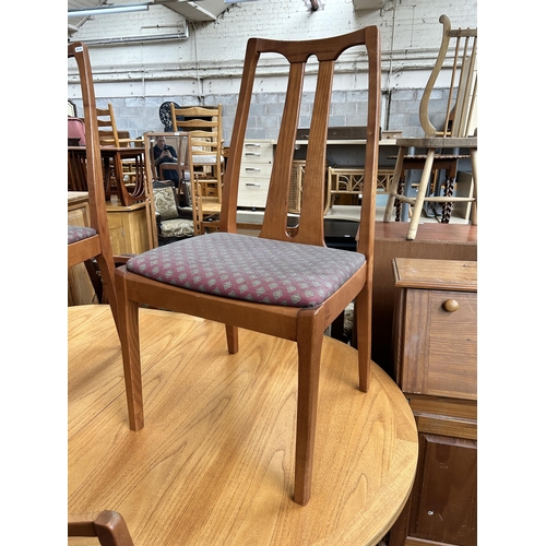 126 - A Parker Knoll teak extending dining table and six chairs