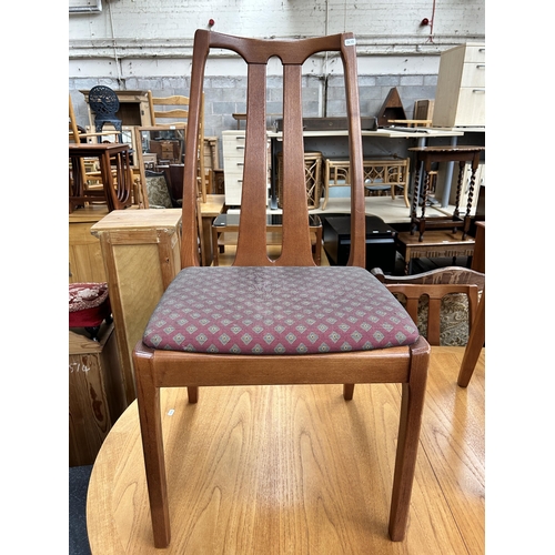 126 - A Parker Knoll teak extending dining table and six chairs