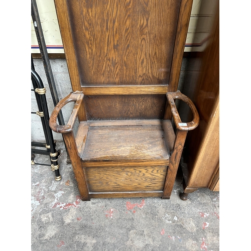 13 - An early 20th century oak hall stand with lidded seat and five coat hooks - approx. 184cm high x 79c... 