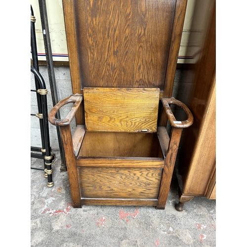 13 - An early 20th century oak hall stand with lidded seat and five coat hooks - approx. 184cm high x 79c... 