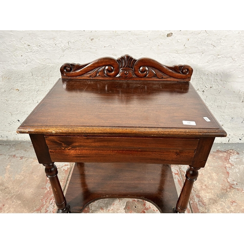 130 - A Victorian style carved mahogany two tier single drawer side table