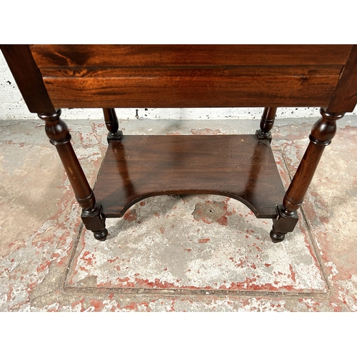 130 - A Victorian style carved mahogany two tier single drawer side table