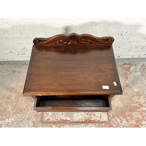 130 - A Victorian style carved mahogany two tier single drawer side table