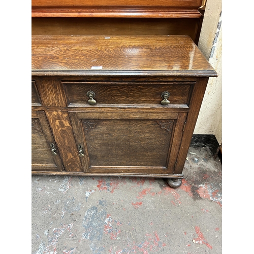 131 - A carved oak sideboard