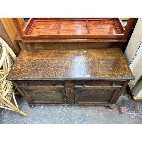 131 - A carved oak sideboard