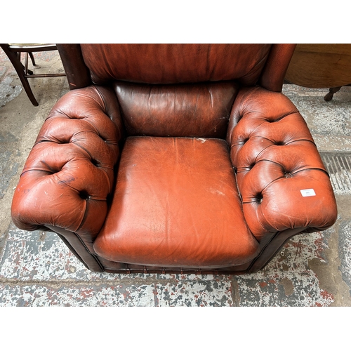 141 - An oxblood red leather Chesterfield armchair