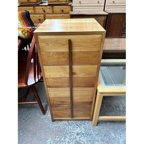 144 - Three pieces of furniture - yew wood and teak chest of drawers, beech and clear glass side table and... 