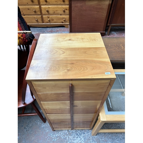 144 - Three pieces of furniture - yew wood and teak chest of drawers, beech and clear glass side table and... 