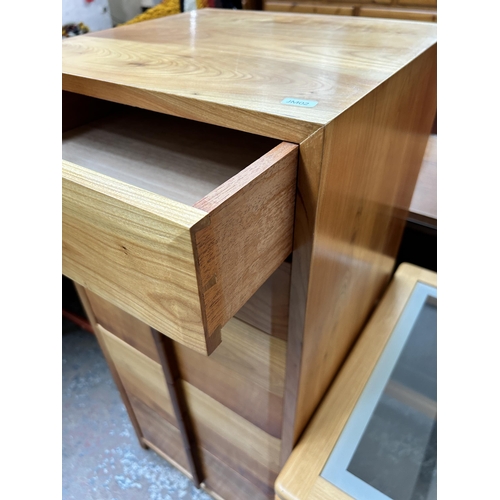 144 - Three pieces of furniture - yew wood and teak chest of drawers, beech and clear glass side table and... 