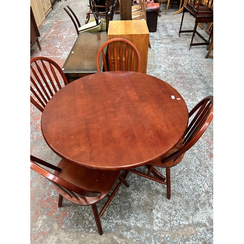 145 - A Malaysian hardwood circular pedestal dining table and four chairs