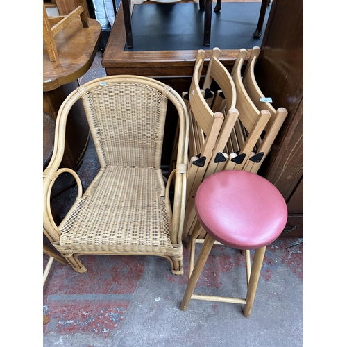 153 - Eleven pieces of house clearance furniture to include four beech folding deck chairs, three pink vin... 