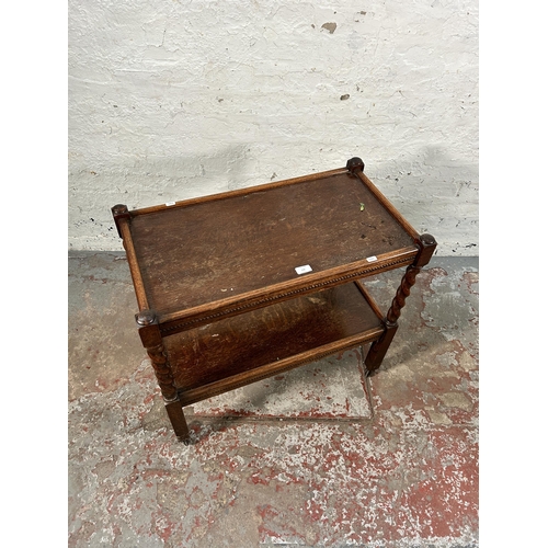 156 - A mid 20th century oak barley twist two tier tea trolley with beaded decoration