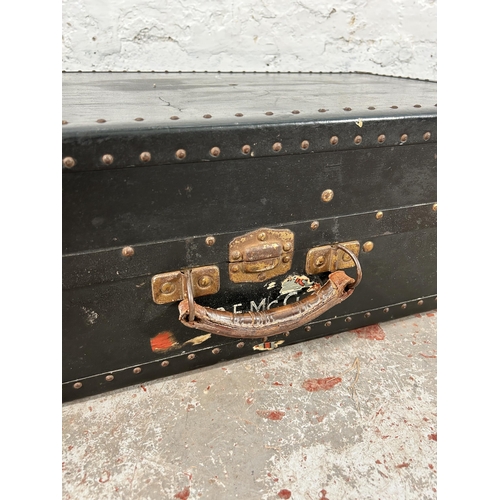 165 - An early 20th century black painted travel trunk with fitted wardrobe