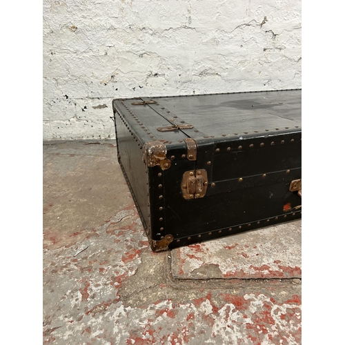 165 - An early 20th century black painted travel trunk with fitted wardrobe