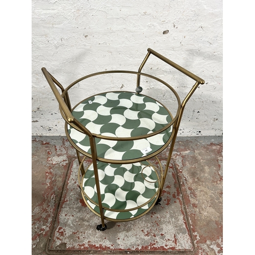 168 - A contemporary gilt metal and plastic two tier circular drinks trolley