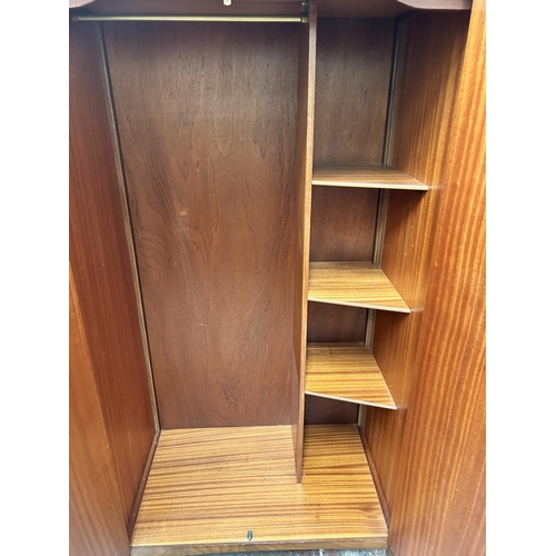 172 - A mid 20th century teak double wardrobe - approx. 174cm high x 91cm wide x 56cm deep