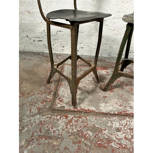 181 - A pair of 1950s Tan-Sad style fibreboard and cast metal industrial machinist's chairs