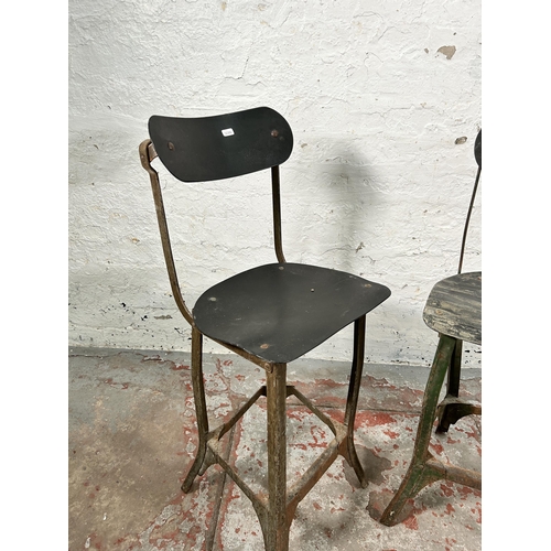 181 - A pair of 1950s Tan-Sad style fibreboard and cast metal industrial machinist's chairs