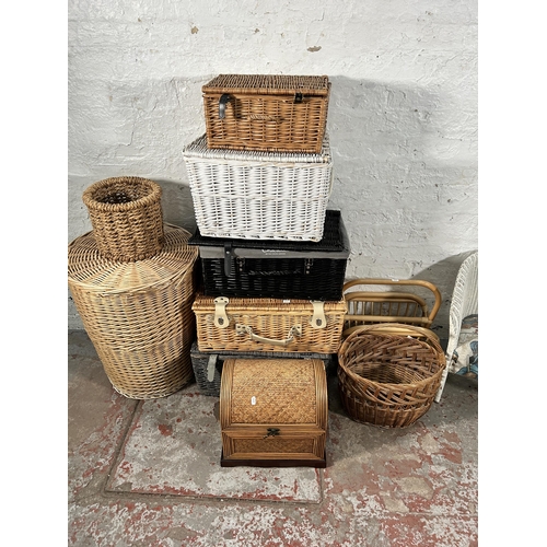 182 - Eleven pieces of wicker furniture to include magazine rack, baskets etc.