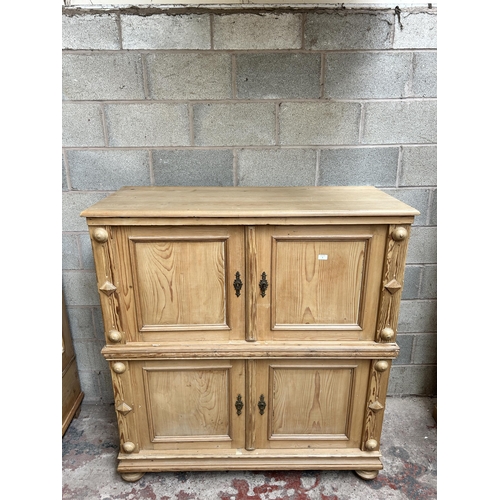 2 - A pine four door housekeeper's cupboard - approx. 144cm high x 55cm wide x 134cm deep