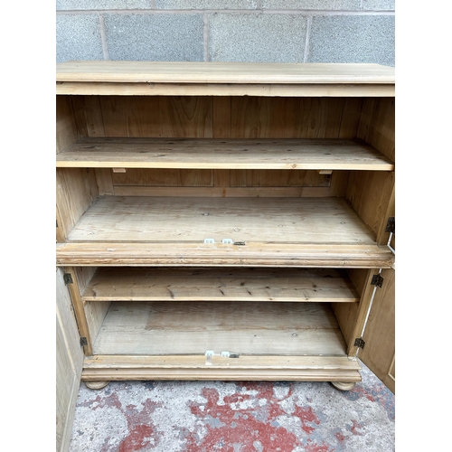 2 - A pine four door housekeeper's cupboard - approx. 144cm high x 55cm wide x 134cm deep