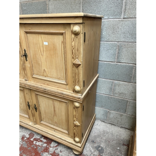 2 - A pine four door housekeeper's cupboard - approx. 144cm high x 55cm wide x 134cm deep